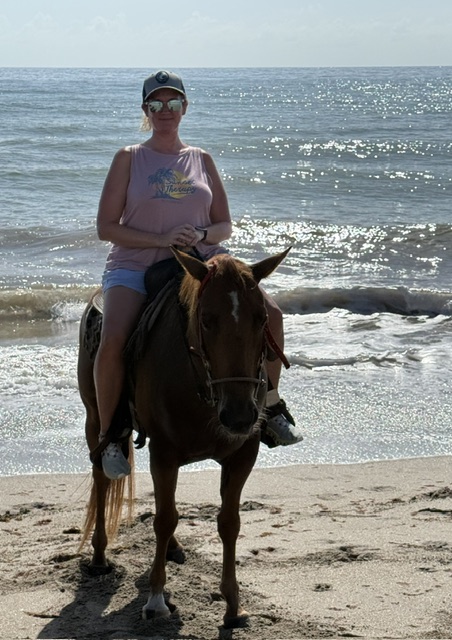 Tarrah on horse at beach